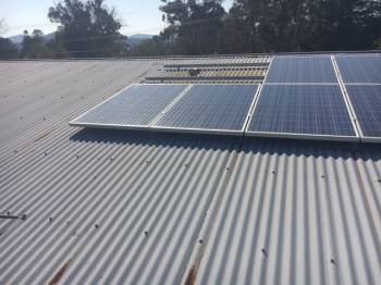 Removing solar panels for Iron Roof Restoration